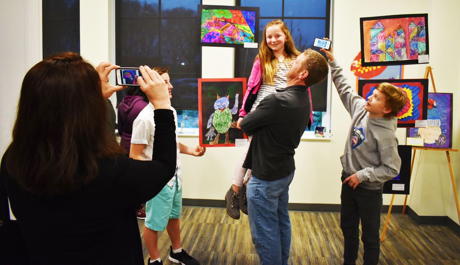 A student and her family check out the art