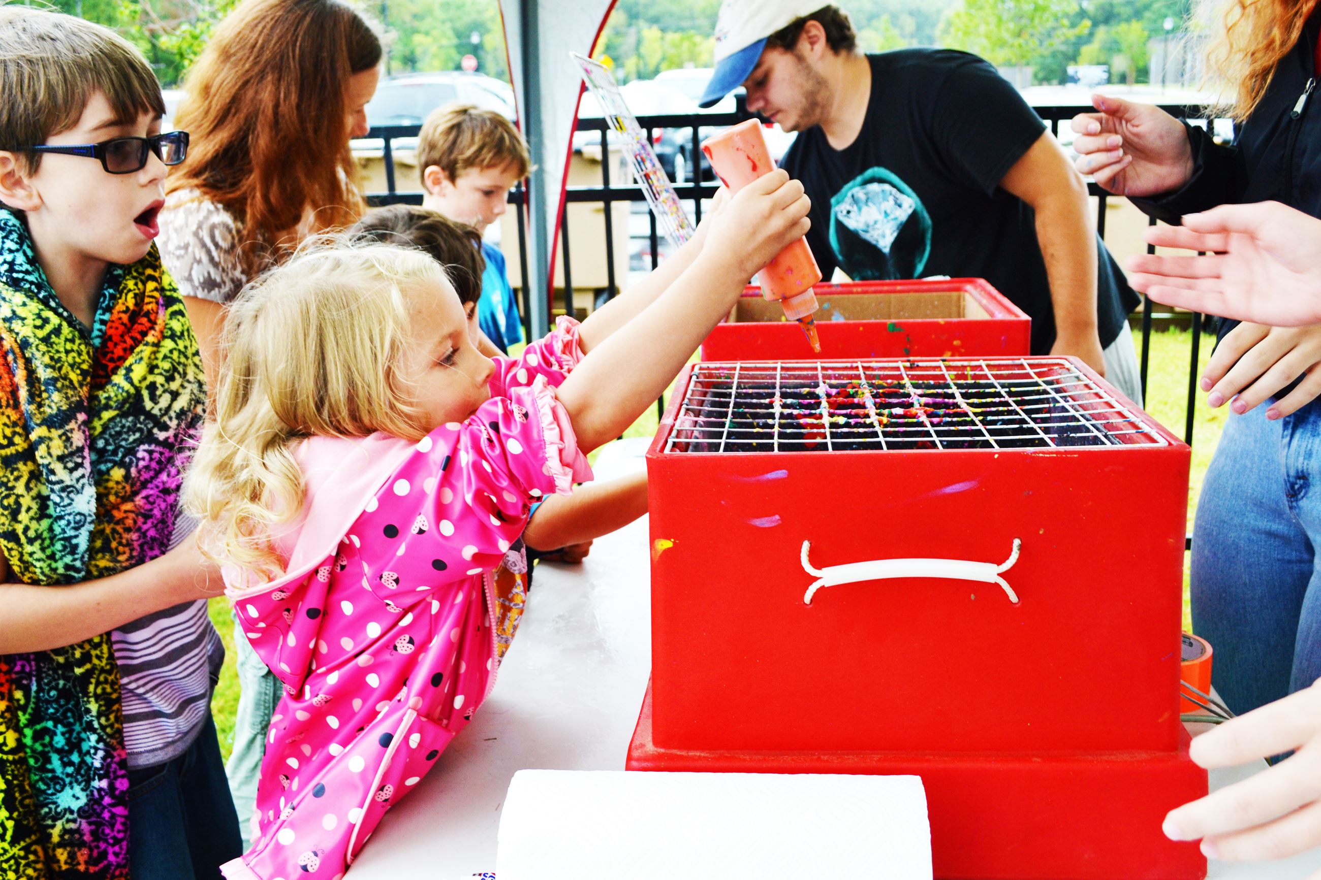 A girl plays with a craft project