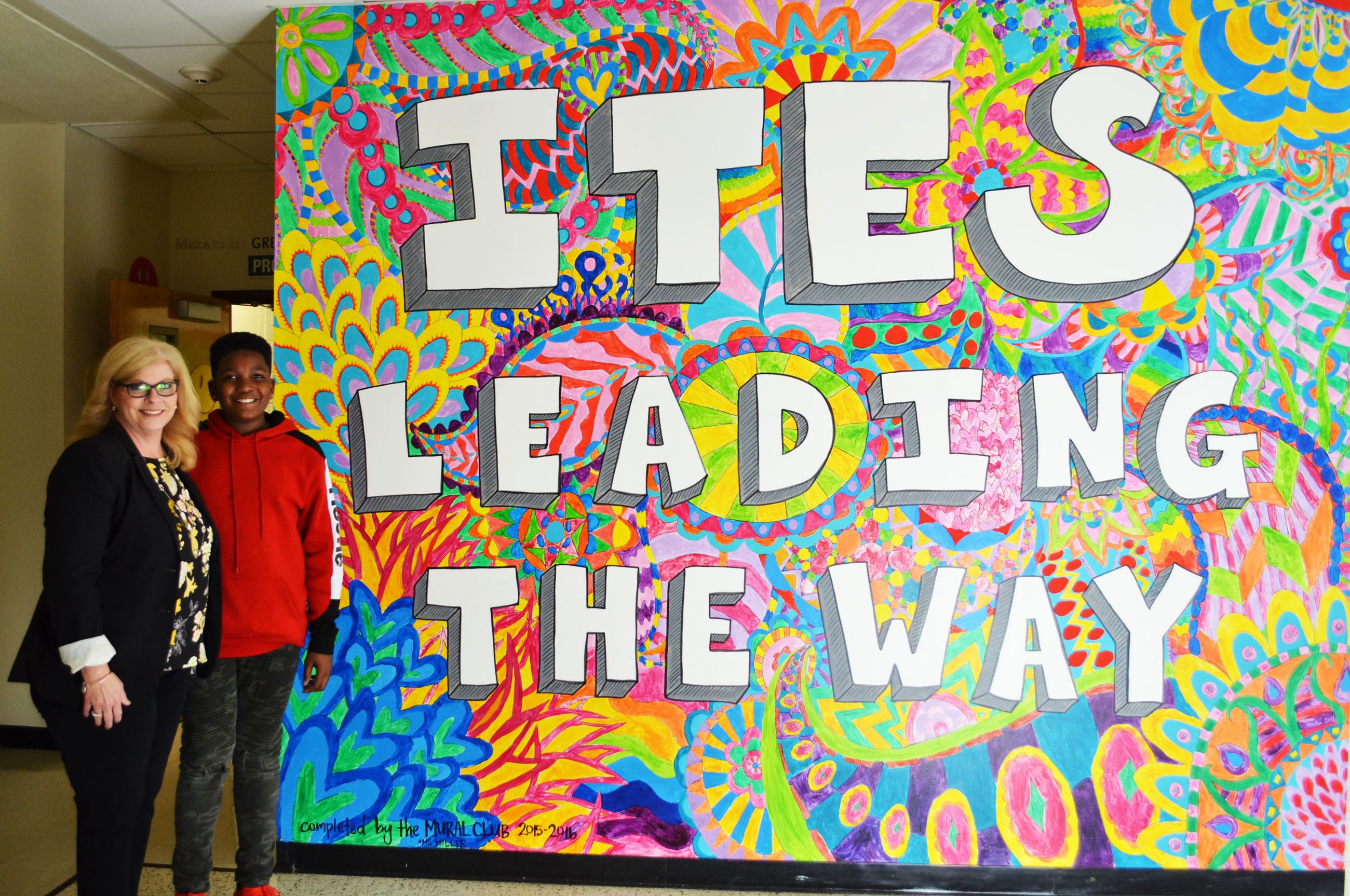 Principal Gina Chisum stands with a future grand marshal, fifth-grader De'aren Coleman.