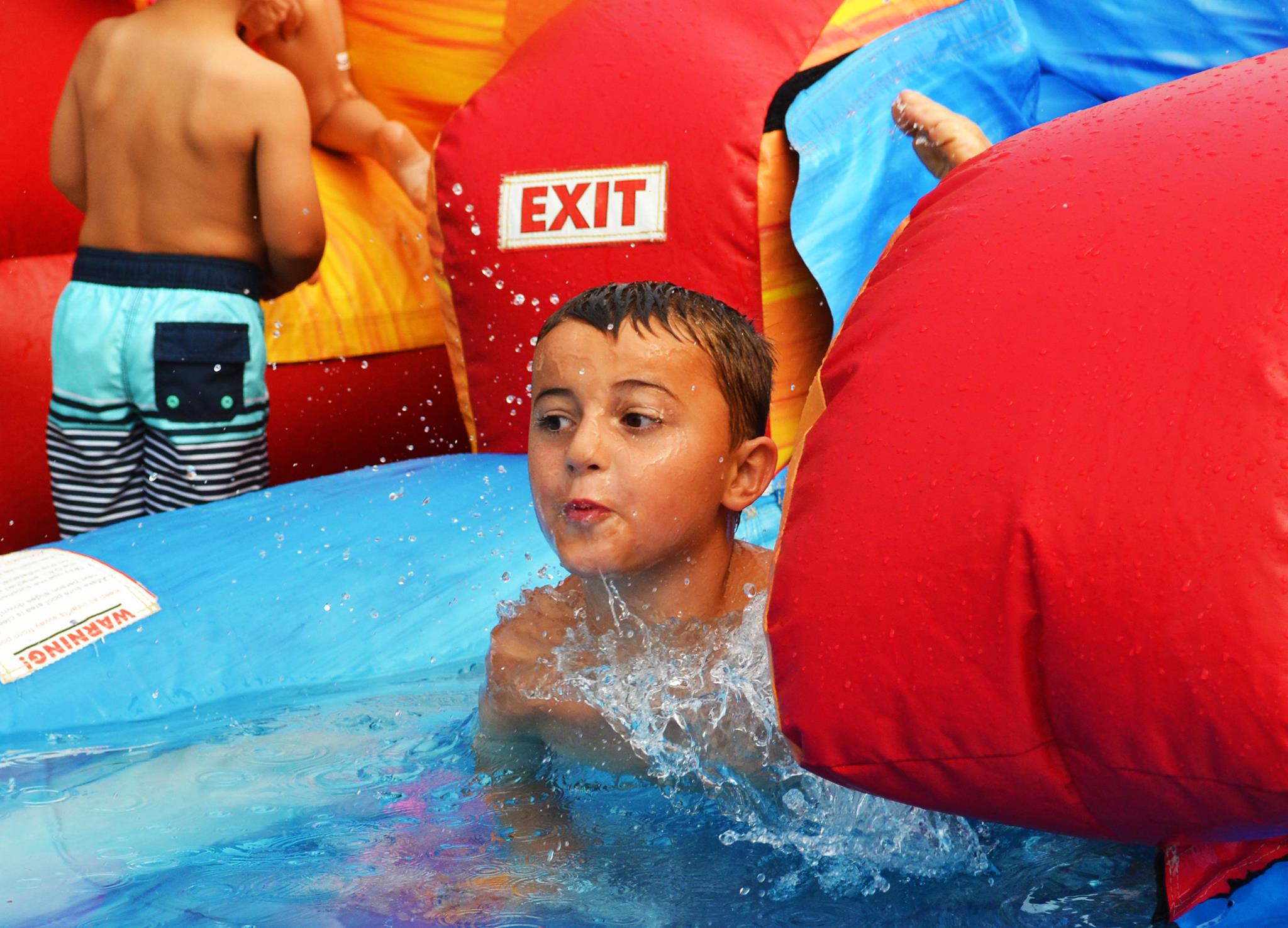 A child goes down the water slide